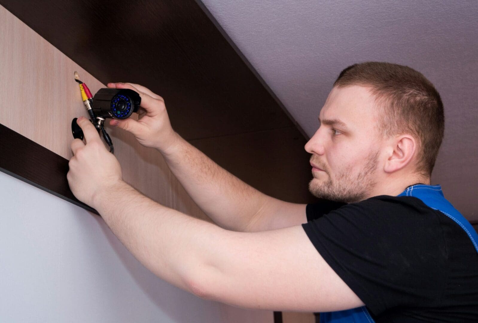 A man holding an electrical device in his hand.