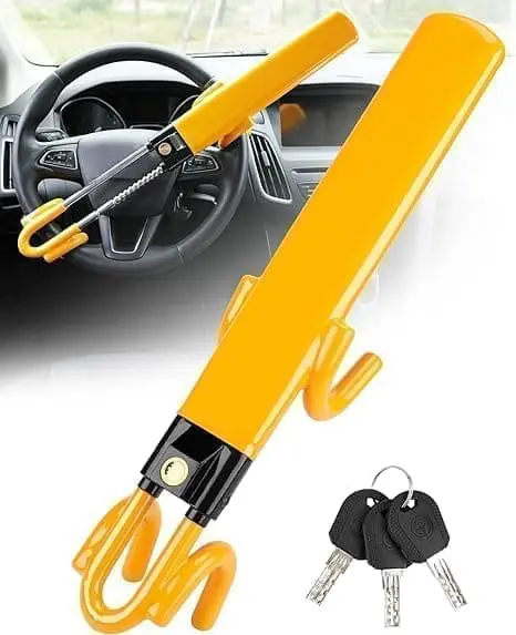 A yellow umbrella with two keys hanging from it.