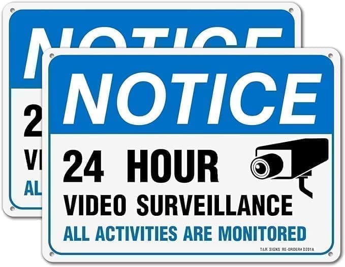 A pair of blue and white signs with instructions on how to use video surveillance.