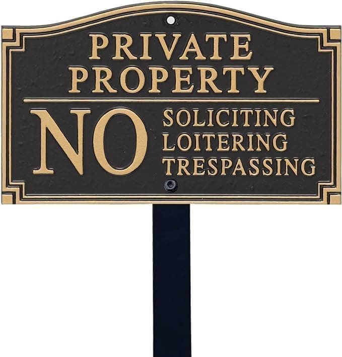 A sign that says private property no soliciting, loitering and trespassing.