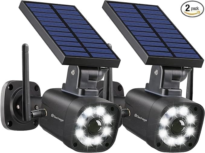 Two solar powered cameras with white lights on them.