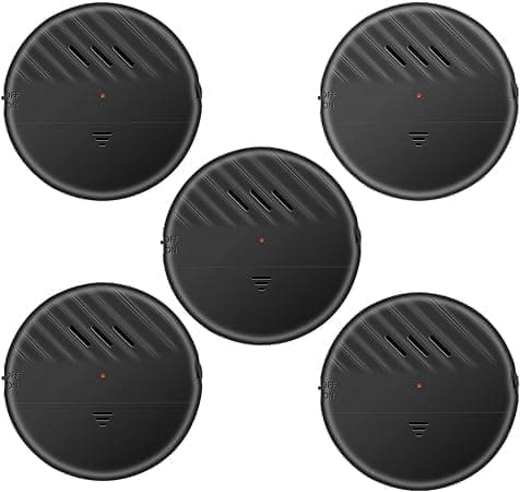 A group of five round black speakers with one red dot.