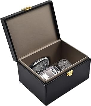 A black leather box with two cell phones inside of it.