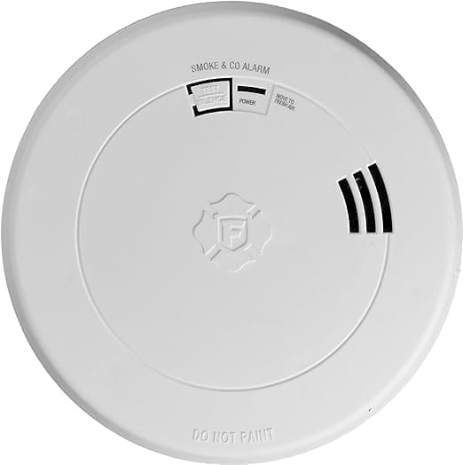 A white smoke alarm with the words " go not paint ".