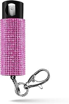 A pink crystal keychain with a key chain attached.