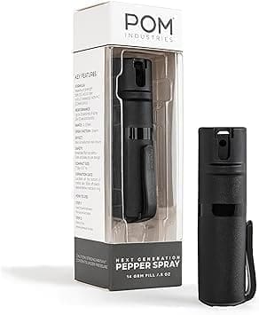 A black pepper spray is next to its packaging.