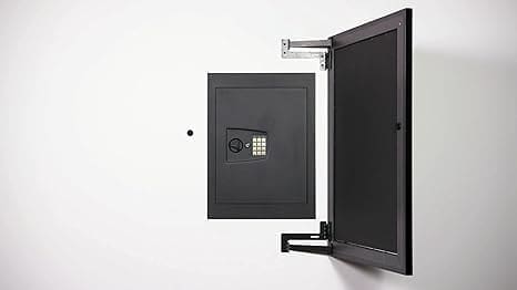 A wall mounted safe with the door open.